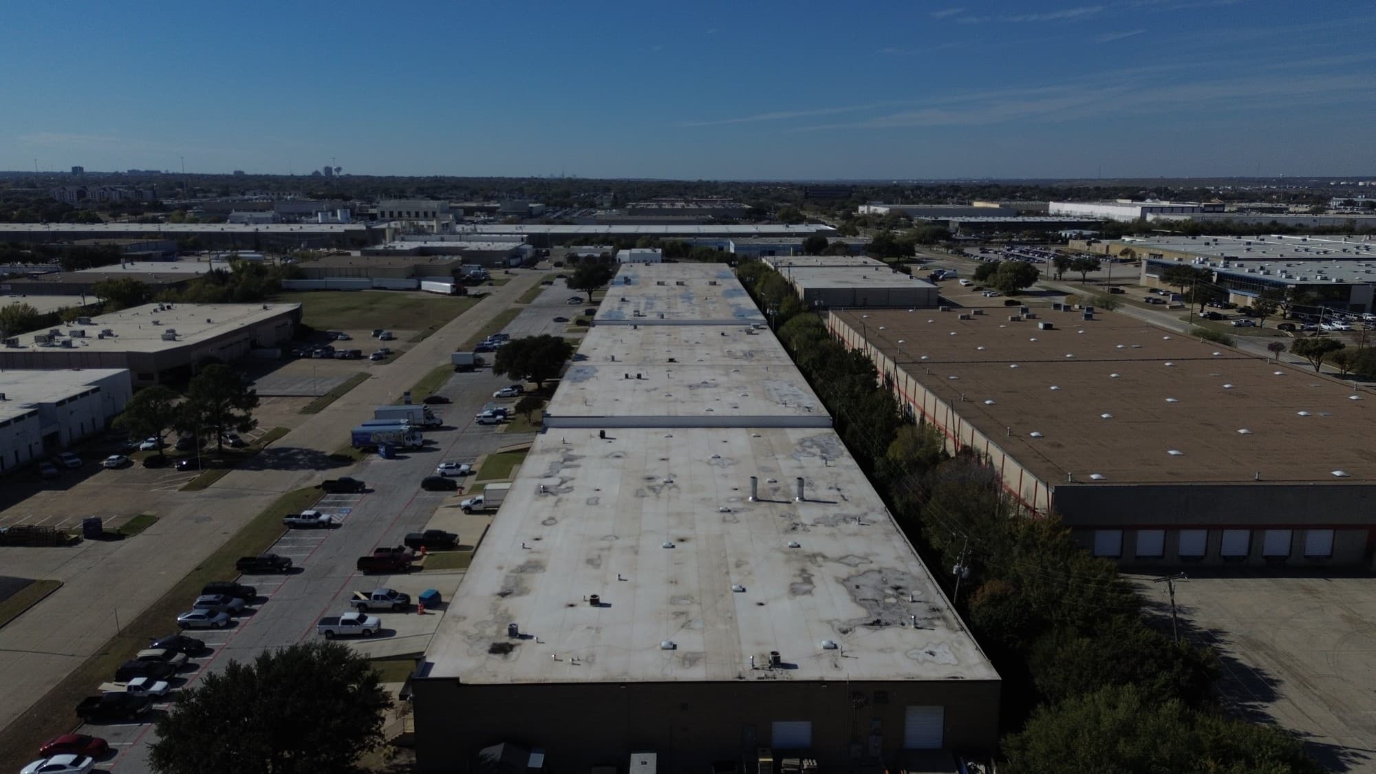 High-altitude drone view of a massive industrial warehouse complex spanning multiple acres